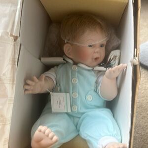 New in box 1996 Ashton-Drake “Andrew” porcelain doll w/lighted firefly detail.